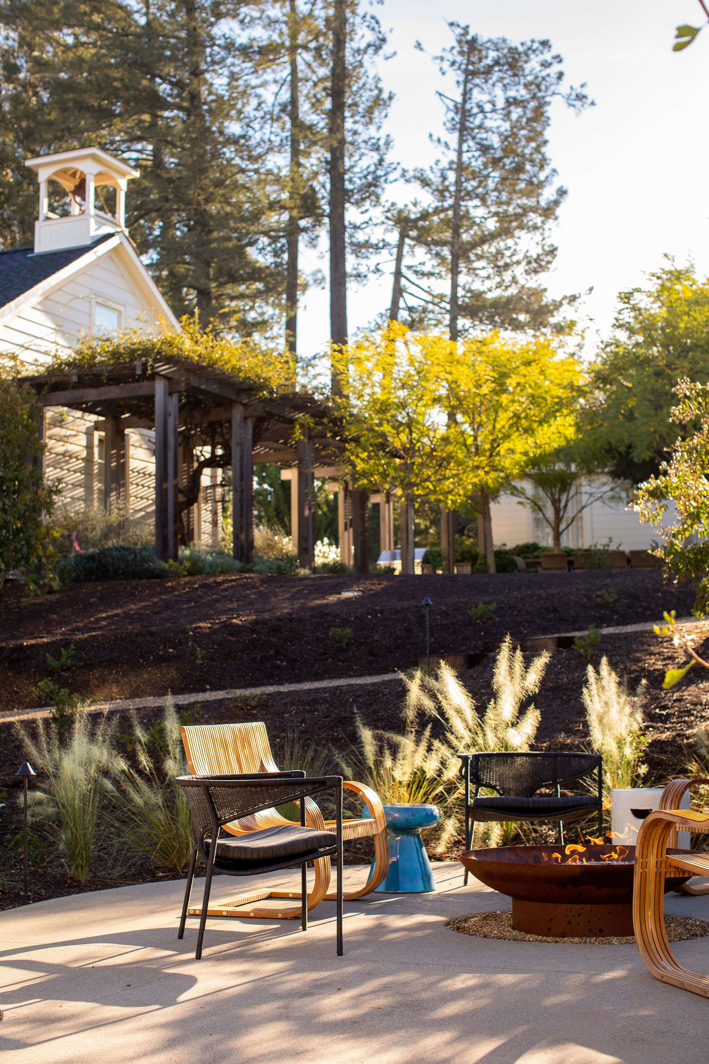 Outdoor Seating Area with Fire Pit Surrounded by Lush Landscape