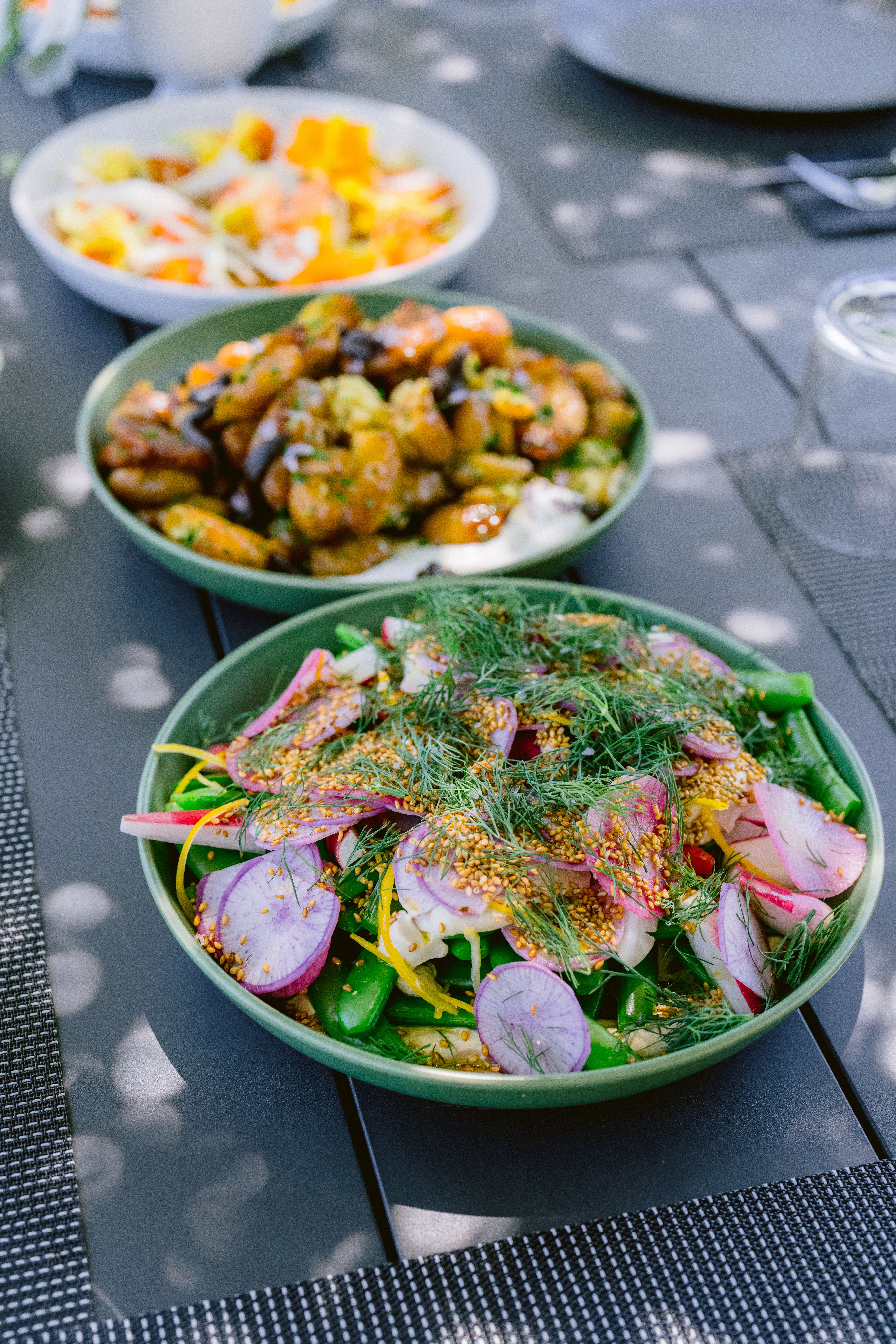 three bowls of food on a table