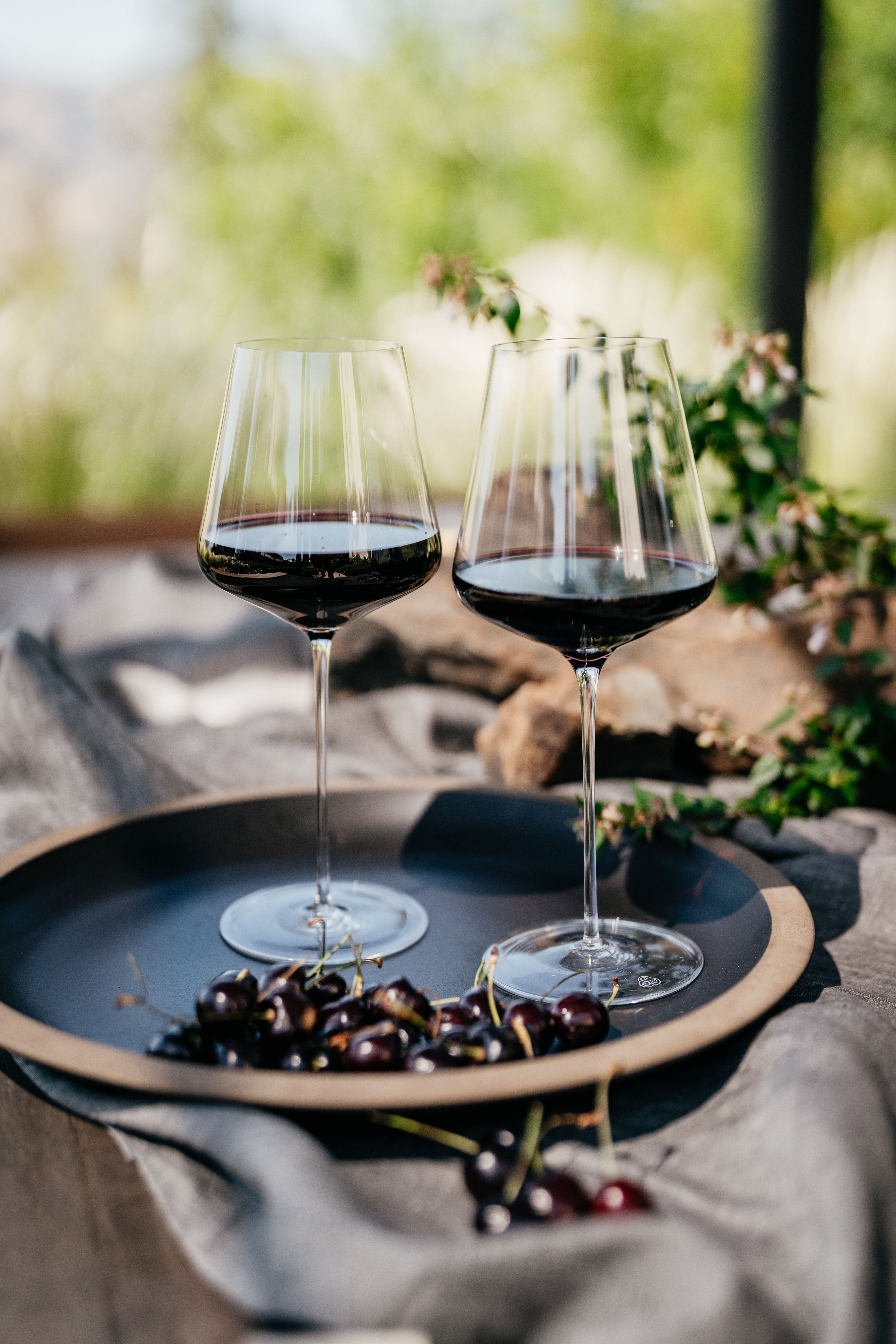 two filled wine glasses on a table